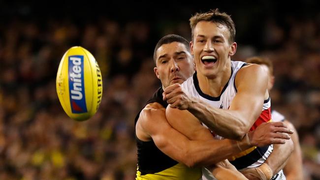 Tom Doedee of the Crows is tackled by Shaun Grigg of the Tigers on Friday night. Picture: Michael Willson/AFL Media/Getty Images