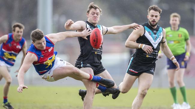 Cygnet’s Paddy O’Neill bumps Huonville’s James McIndoe off the ball. Picture: Chris Kidd