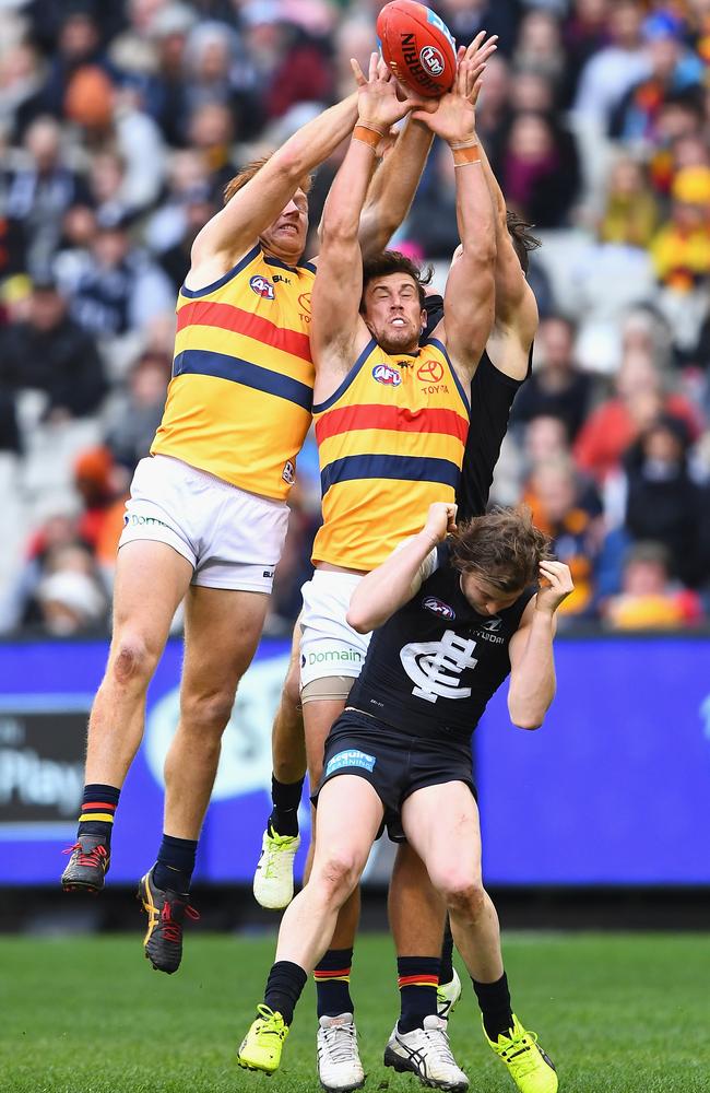 Kyle Cheney and Kyle Hartigan compete for a mark and shut down Andrejs Everitt. (Photo by Quinn Rooney/Getty Images)