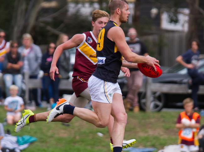 Justin Sherman looks upfield for Whittlesea against Lower Plenty in their NFL clash. Picture: Steve McNeil.