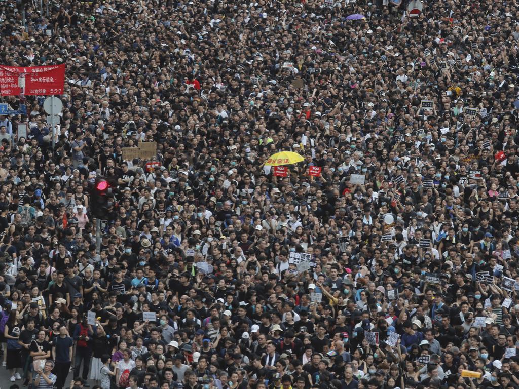 Thousands of people, many wearing black shirts and some carrying British flags, were marching in Hong Kong. Picture: AP