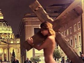 ONE TIME WEB USE ONLY - FEE APPLIES FOR REUSE - A Playboy model has been arrested for posing naked at the Vatican while shouldering a large wooden crucifix in the latest of a series of controversial stunts. Picture: CEN/australscope