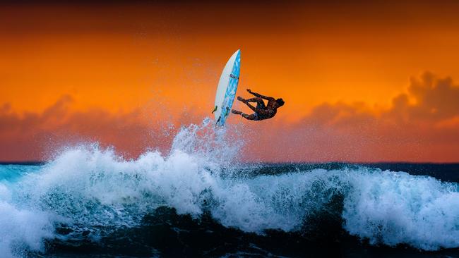 A young surfer makes the most of the evening waves in Hikkaduwa, Sri Lanka. Picture: Thusitha Jayasundara