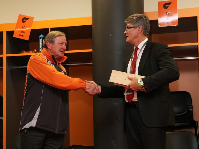 AFL chairman Mike Fitzpatrick presents then GWS coach Kevin Sheedy with a 1980 bottle of Grange Hermitage after his last home match as coach before retiring. Picture: Phil Hillyard