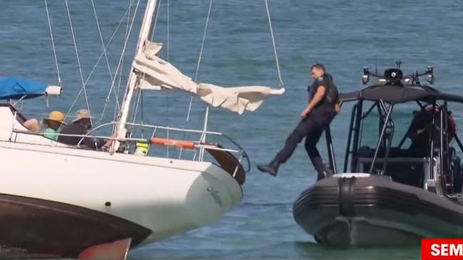 Police rescue some boaties after their yacht becomes stuck on a sandbar off of Semaphore . Picture: 7NEWS