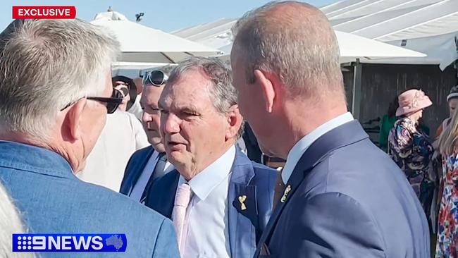 Corrupt former mayor Paul Pisasale was spotted at the Ipswich Cup chatting with Wolston Correctional Centre residential manager Patrick Ralph (left) and Queensland Police Union boss Ian Leavers (right). Source: 9NEWS.