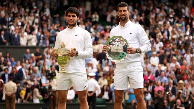 Carlos Alcaraz of Spain (L) holds the Men's Singles Trophy alongside Novak Djokovic with the Men's Singles Runner's Up Plate. Picture: Getty Images.