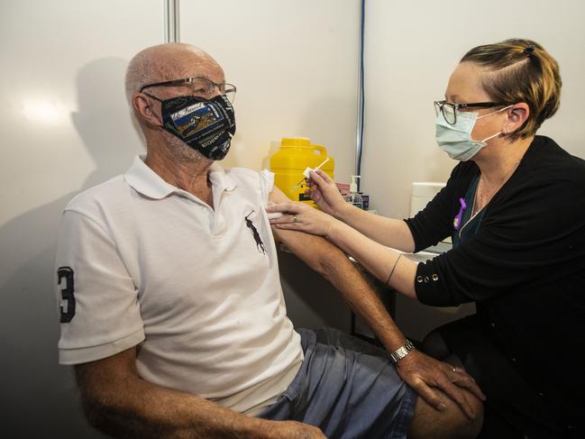 PERTH, AUSTRALIA - APRIL 28: 84 year old Dom Musitano is seen getting his COVID-19 vaccine as WA Premier Mark McGowan and Health Minister Roger Cook tour the clinic at Claremont Showgrounds  Covid-19 Vaccine Centre on April 28, 2021 in Perth, Australia. Premier Mark McGowan has announced the opening of two new COVID-19 vaccination clinics in Perth, open to eligible Western Australians at the Claremont Showgrounds and Perth Airport. (Photo by Michael Wilson - Pool/Getty Images)