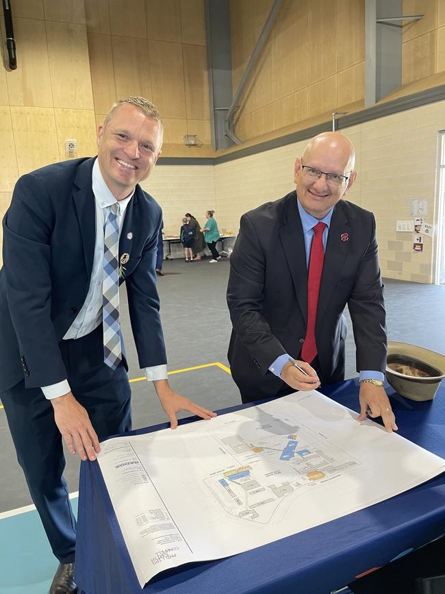 Ripley Valley State Secondary College principal, Brendan Krueger and Blair MP Shayne Neumann inspect the plans for the school's memorial.