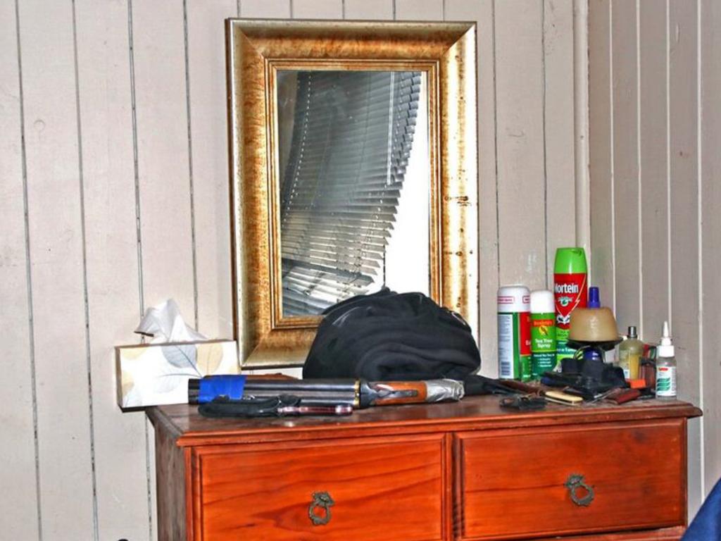 A gun sits on top of a dresser inside the Train property.