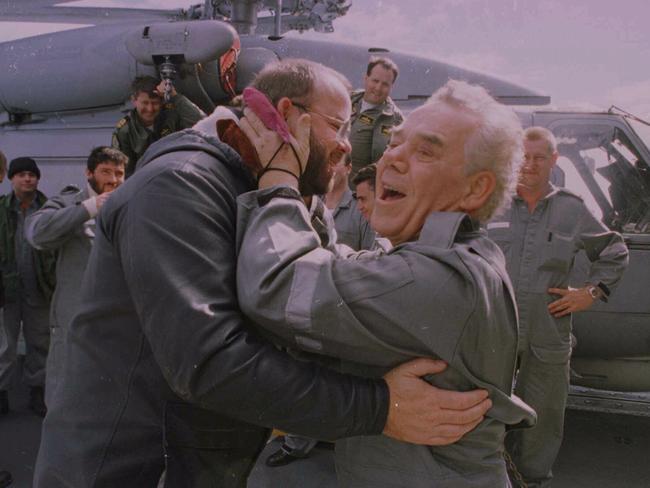 Bullimore (right) gives Chief Petty Officer Peter Wicker a kiss for pulling him from the freezing waters of the Southern Ocean days earlier.