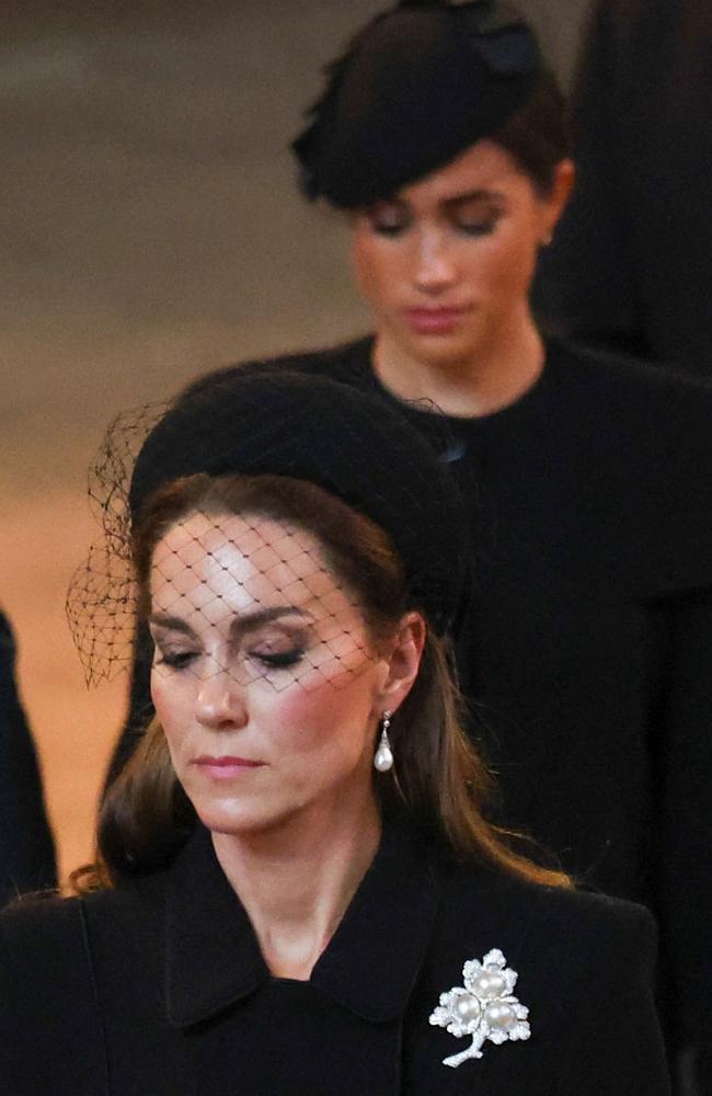 Kate, Princess of Wales and Meghan, Duchess of Sussex, walk as the coffin of Queen Elizabeth II arrives at the Palace of Westminster. Picture: AFP.