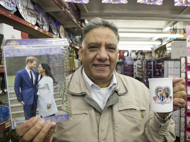 Shop-keeper Malkit Aujla with souvenirs commemorating the upcoming wedding of Prince Harry and Meghan Markle. Picture: Ella Pellegrini