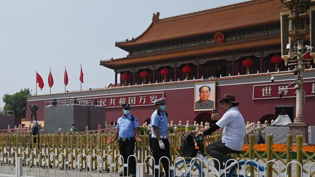 Police stand guard on Wednesday in front of Tiananmen Gate in Beijing, where Xi Jinping will oversee a red centenary parade on Thursday. Picture: AFP