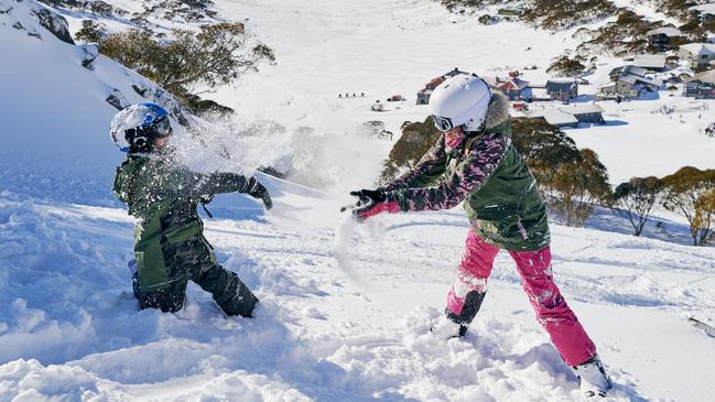 Children enjoying a snow fight at Charlottes Pass in the Snowy Mountains. Picture: Destination NSW