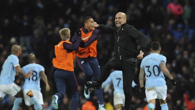 Manchester City manager Josep Guardiola celebrates wildly.