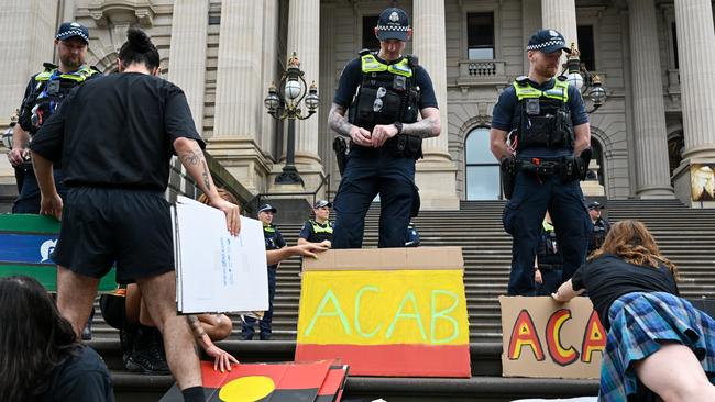 Police watch over the protest crowds at Parliament House. Picture: Getty Images