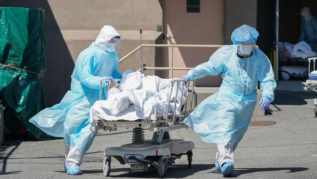 Bodies are moved to a refrigeration truck serving as a temporary morgue at Wyckoff Hospital in Brooklyn, New York. Picture: AFP