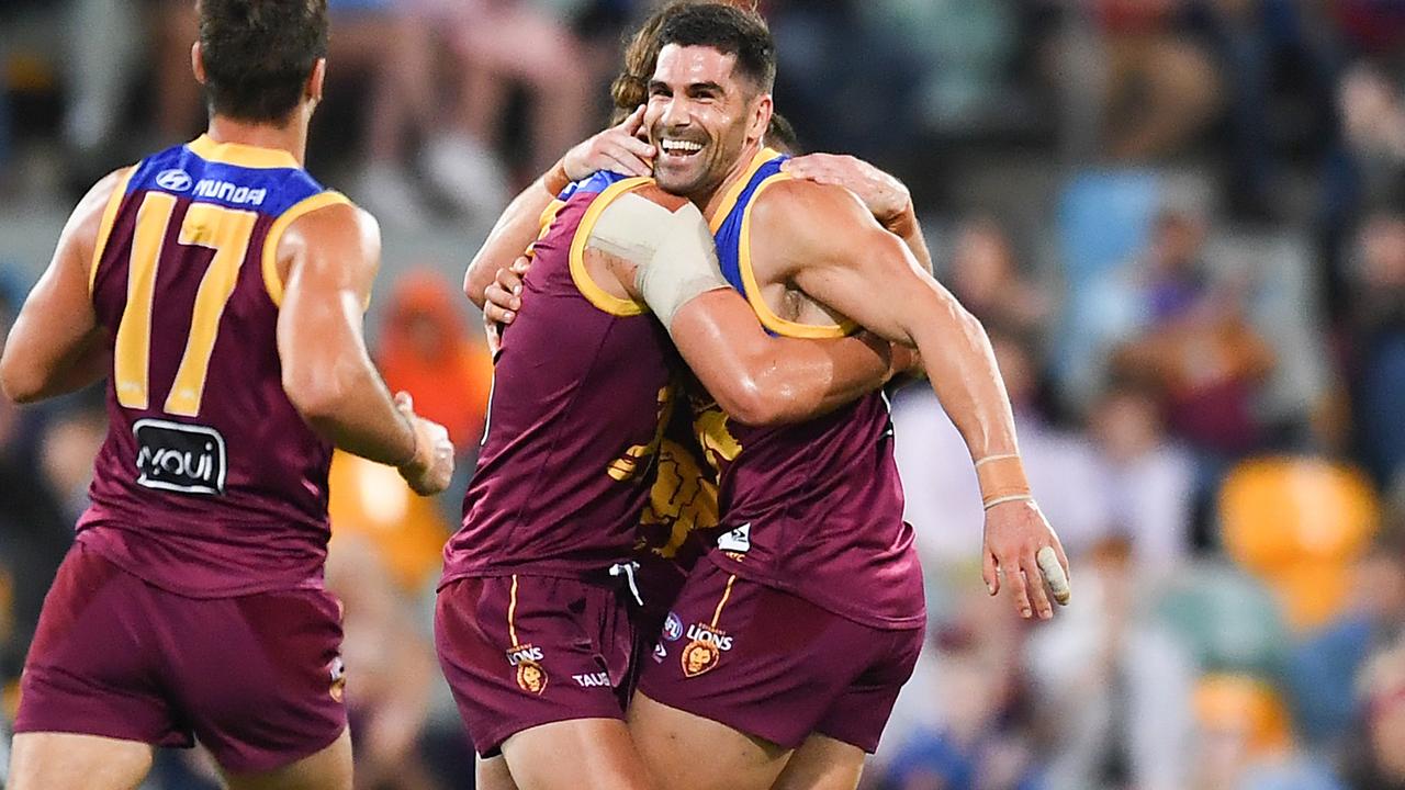 BRISBANE, AUSTRALIA - APRIL 14: Marcus Adams of the Lions celebrates with team mates after kicking a goal during the round five AFL match between the Brisbane Lions and the Collingwood Magpies at The Gabba on April 14, 2022 in Brisbane, Australia. (Photo by Albert Perez/AFL Photos/Getty Images)