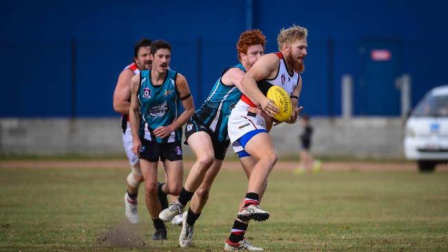 Bulldogs Jefferson Baulch gets tackled by Power's Lachlan Smith.