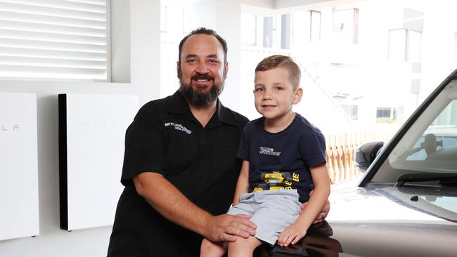 DAILY TELEGRAPH 12TH DECEMBER 2023Pictured at their home in North Kellyville is Luke Spicer and his son Elijah.Luke has installed solar and uses Tesla batteries to power his home.Picture: Richard Dobson