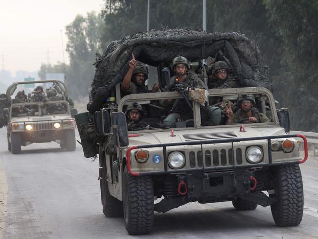 Israeli soldiers patrol a road near the border fence with Gaza. Picture: AFP