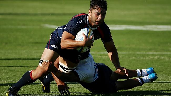 Rebels flanker Colby Fainga'a gets tackled. Picture: Colleen Petch.