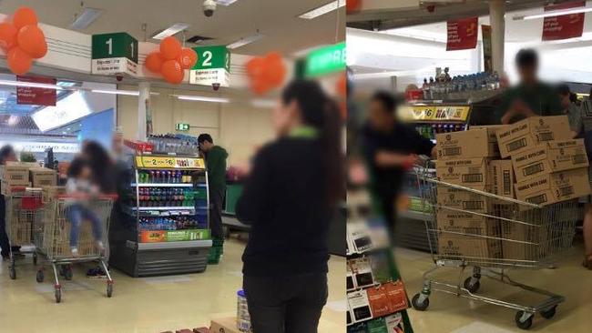 A Melbourne mother snapped this picture of a group of four taking almost every tin of a rare baby formula from a Woolworths store at Epping Plaza.