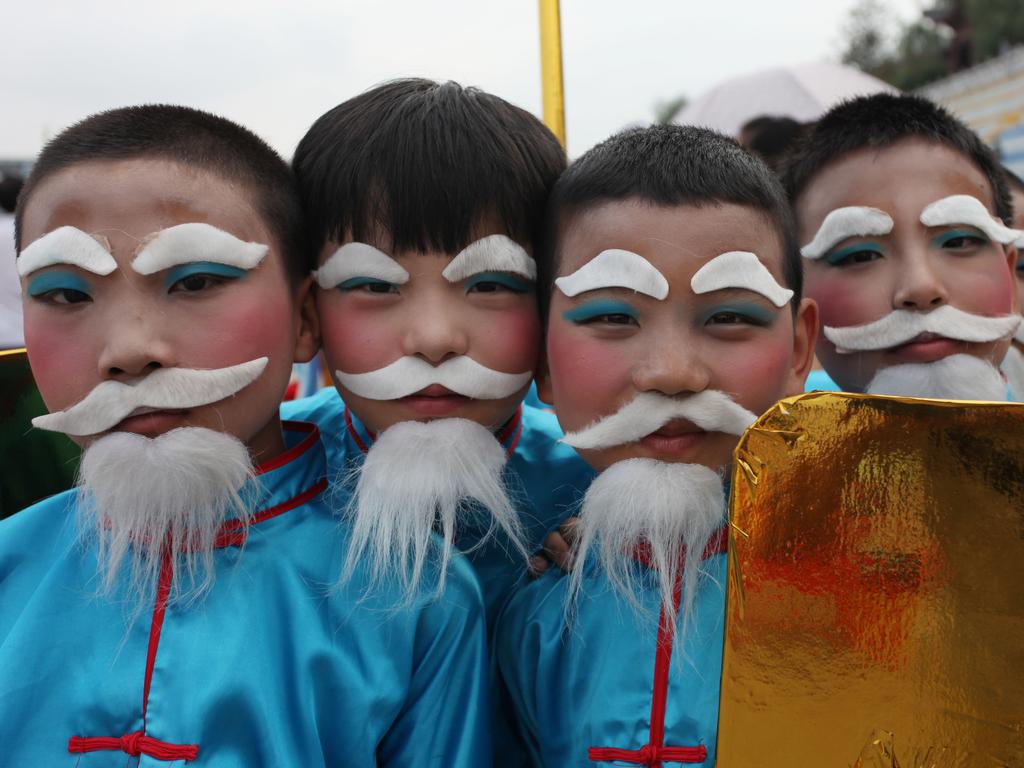 Performers pose during rehearsal of 15th China Ankang Hanjiang River Dragon Boat Festival on June 18, 2015 in Ankang, Shaanxi Province of China. Picture: Getty