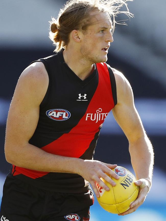 Mason Redman looks to send Essendon in attack against Collingwood.