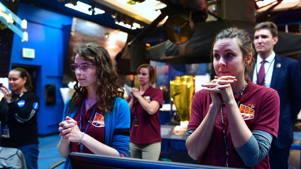 Employees of NASA's Jet Propulsion Laboratory (JPL) react while watching the landing of the InSight on Mars. Picture: AFP