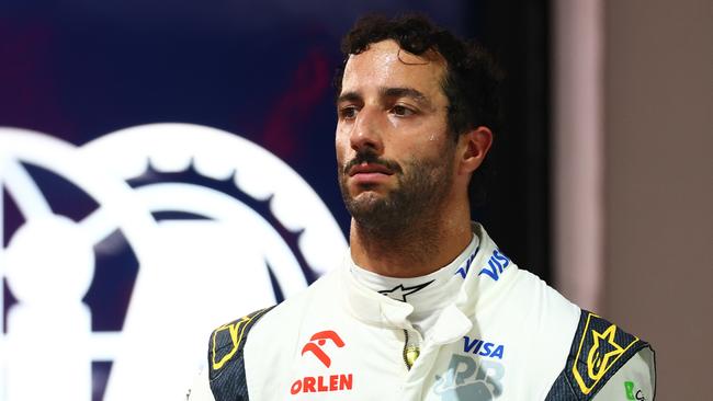 SINGAPORE, SINGAPORE - SEPTEMBER 21: 16th placed qualifier Daniel Ricciardo of Australia and Visa Cash App RB walks in the Pitlane during qualifying ahead of the F1 Grand Prix of Singapore at Marina Bay Street Circuit on September 21, 2024 in Singapore, Singapore. (Photo by Mark Thompson/Getty Images)