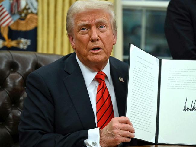 TOPSHOT - US President Donald Trump signs an executive order in the Oval Office of the White House on February 10, 2025, in Washington, DC. (Photo by ANDREW CABALLERO-REYNOLDS / AFP)