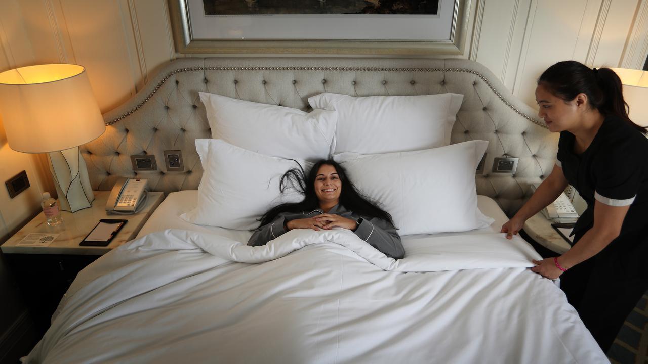 Beatriz Soares settles in for a good night’s sleep at The Langham in Sydney, after being tucked in by housekeeping attendant Anjali Bhujel. Picture: John Feder