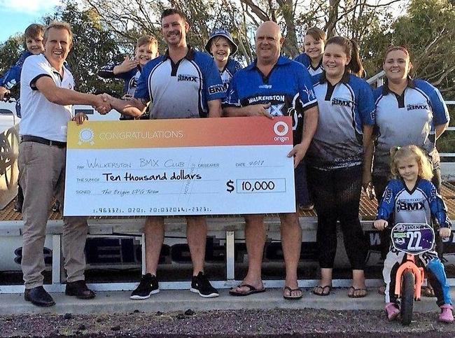 Geoff Berger, of Origin Energy, presents the $10,000 grant to Justin Skaines, Ian and Bronti Whitmore, Kirsty and Sienna Skaines and (back) Aiden Parish, Tyler Skaines, Connor Parish and Liam Skaines. Picture: Contributed