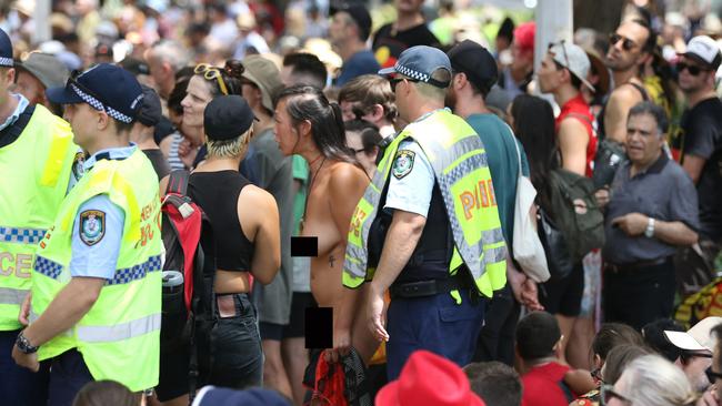 Police speak to a naked protester at an Invasion Day march in Sydney on January 26, 2020. Picture: Richard Milnes/Shutterstock