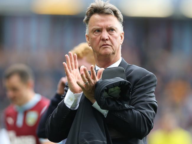 Manchester United’s Dutch manager Louis van Gaal applauds the fans as he leaves the pitch after the final whistle in the English Premier League football match between Burnley and Manchester United at Turf Moor in Burnley, north west England on August 30, 2014. The match ended 0-0. AFP PHOTO / IAN MACNICOL RESTRICTED TO EDITORIAL USE. No use with unauthorized audio, video, data, fixture lists, club/league logos or “live” services. Online in-match use limited to 45 images, no video emulation. No use in betting, games or single club/league/player publications