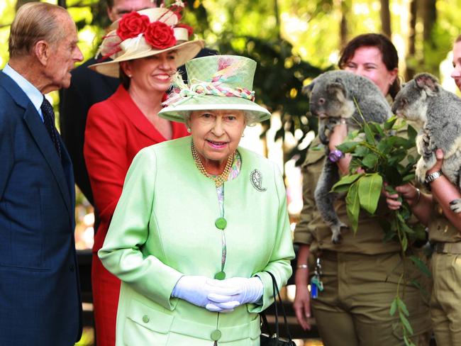 Her Majesty Queen Elizabeth II beside a koala while Prince Philip, Duke of Edinburgh and QLD Premier Anna Bligh talk to wildlife officers. Picture: Supplied