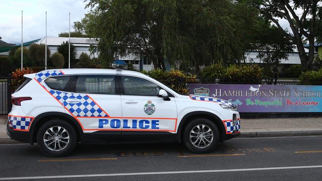 Police officers attend Hambledon State School at Edmonton, where a 3 year old was found dead in a Goodstart Early Learning Centre minibus at around 3:30pm on Tuesday. A police forensic officer inspects the van. PICTURE: BRENDAN RADKE