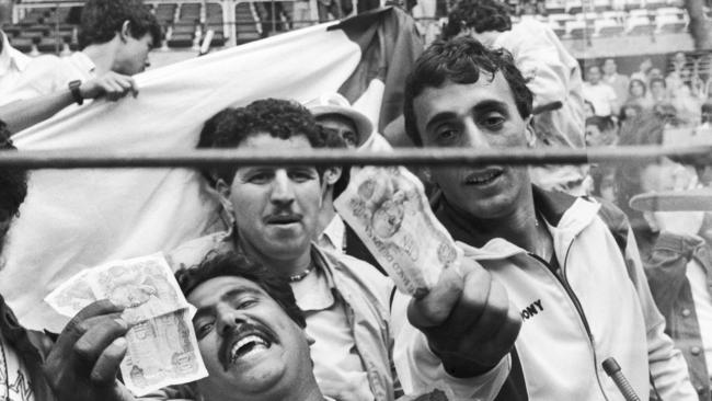 Algerian soccer fans show money to photographers, in Gijon, Spain, after the controversial match between West Germany and Austria. Pic: AP