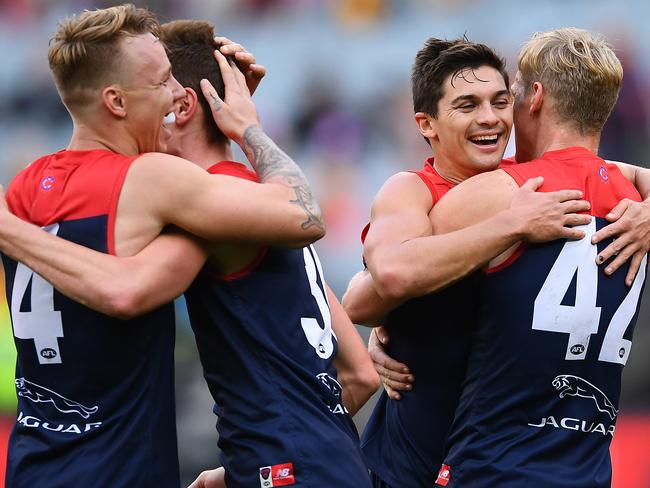 MELBOURNE, AUSTRALIA - MAY 04: James Harmes, Bayley Fritsch, Jay Lockart and Josh Wagner of the Demons celebrate winning the round seven AFL match between the Melbourne Demons and the Hawthorn Hawks at Melbourne Cricket Ground on May 04, 2019 in Melbourne, Australia. (Photo by Quinn Rooney/Getty Images)