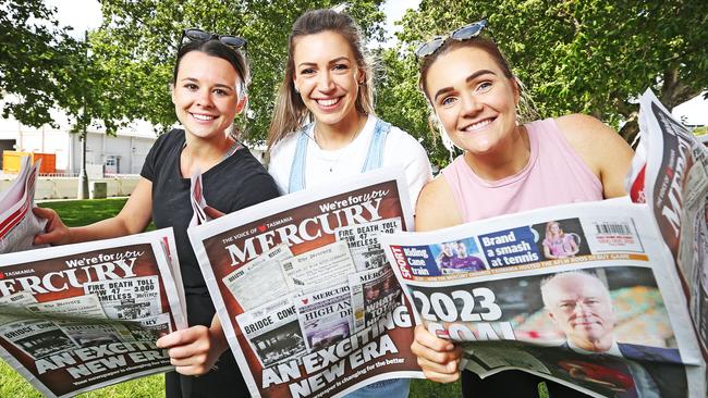 Holly Smith, of Montagu Bay, Jessica Healy, of Sandy Bay, and Victoria McDougall, of Geilston Bay, enjoy reading the Mercury newspaper. Picture: ZAK SIMMONDS