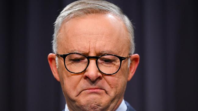 Australian Prime Minister Anthony Albanese surrounded by members of the First Nations Referendum Working Group gets emotional as he speaks to the media during a press conference at Parliament House in Canberra, Thursday, March 23, 2023. (AAP Image/Lukas Coch) NO ARCHIVING