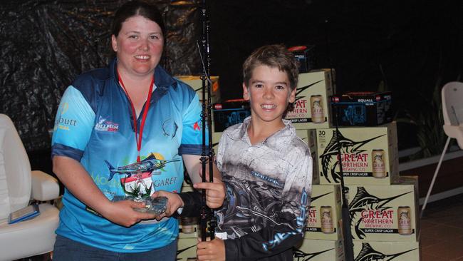 Mackay’s Matthew Colborne collects his Townsville Billfishing Challenge junior champion trophy from Renee McKenzie, secretary of the Townsville Gamefishing Club.