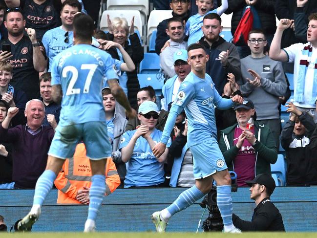 Manchester City midfielder Phil Foden (R) struts after scoring his team's fourth goal against Newcastle United. Picture: Paul Ellis/AFP