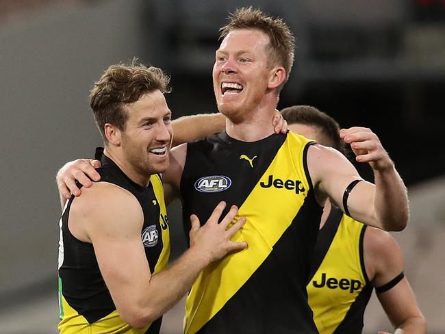 MELBOURNE, AUSTRALIA - JULY 05: Kane Lambert of the Tigers (L) celebrates with teammates Jack Riewoldt of the Tigers after kicking a goal during the round 5 AFL match between the Melbourne Demons and the Richmond Tigers at Melbourne Cricket Ground on July 05, 2020 in Melbourne, Australia. (Photo by Graham Denholm/AFL Photos via Getty Images)