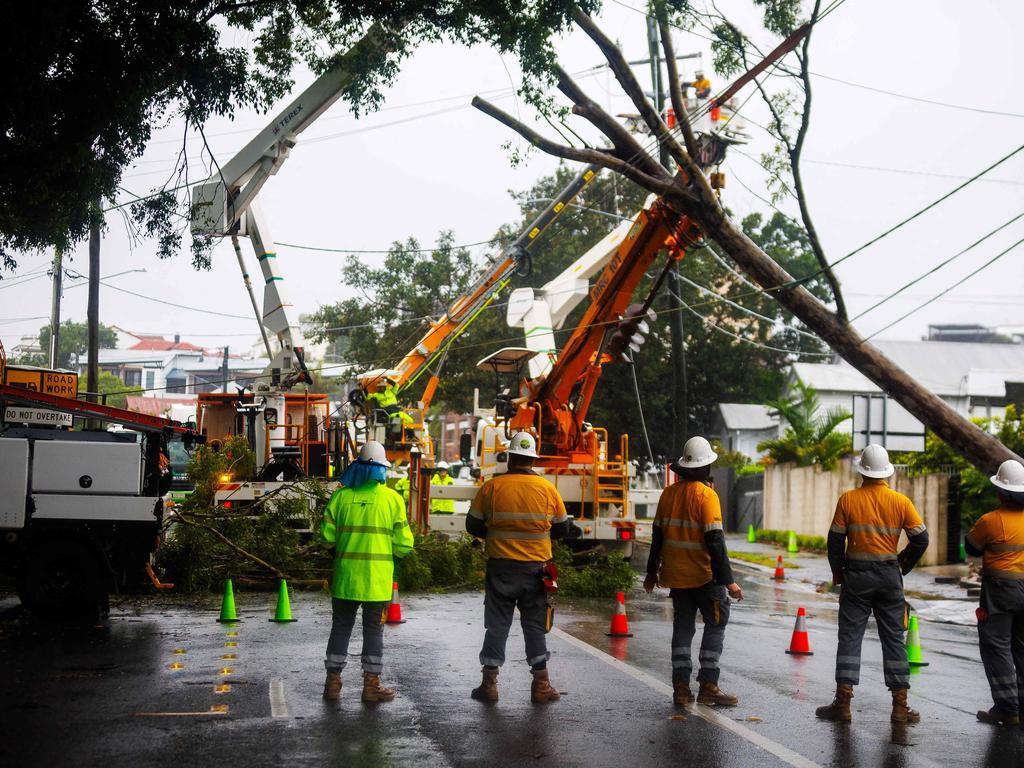 Energex crews clear a fallen tree following the passage of tropical cyclone Alfred in Brisbane on March 8. Picture: Patrick HAMILTON / AFP