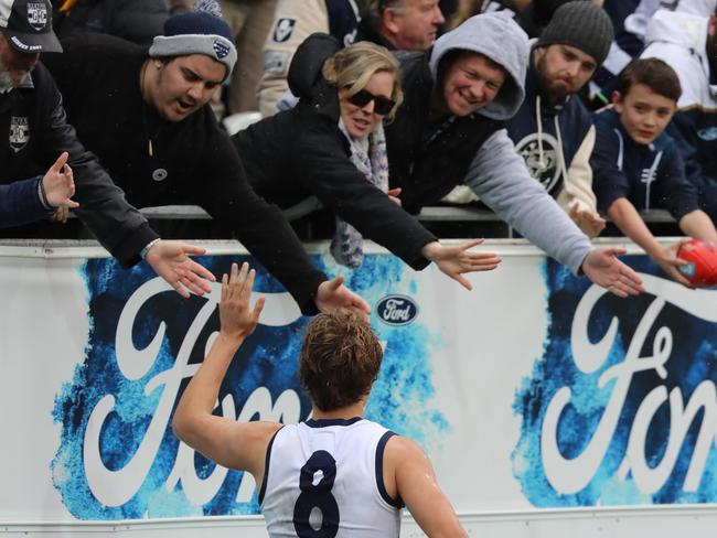 Jake Kolodjashnij celebrates the win with Cats fans. Picture: Alex Coppel