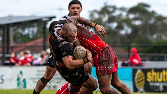 Picton’s Alec Susino on the end of a crunching tackle. Picture Thomas Lisson