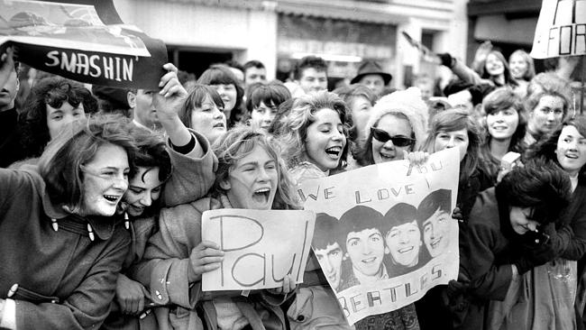 Excited fans line Exhibition Street to see The Beatles during their tour of Melbourne in 